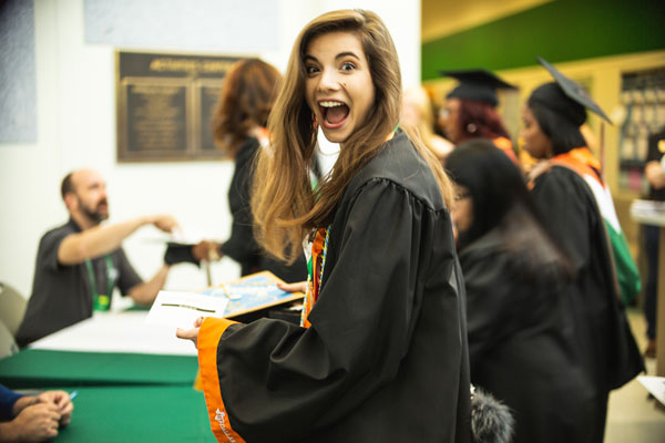 Ana-Maria Frampton checks in for her graduation ceremony. Frampton earned a bachelor’s degree in global business and marketing.