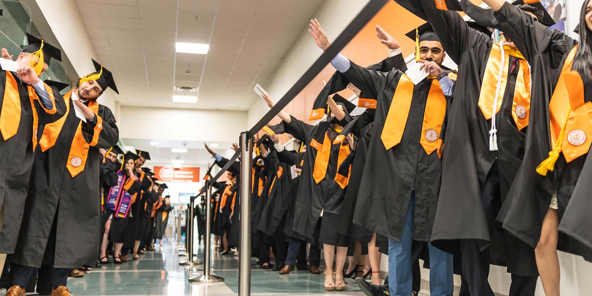 Before their commencement ceremony, students from the Naveen Jindal School of Management practiced the Whoosh, a sign designed for Comets to show their school spirit.